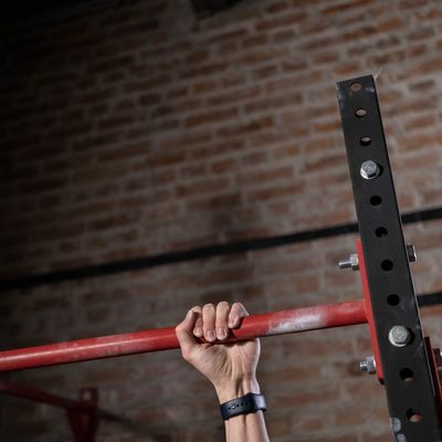 Athlete's hands gripping a pull-up bar, showing determination.
