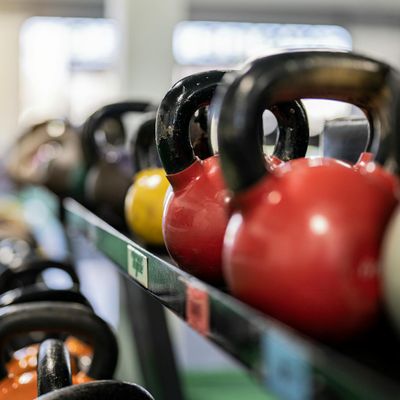 Close-up on a kettlebell on a gym floor, symbolizing strength equipment.